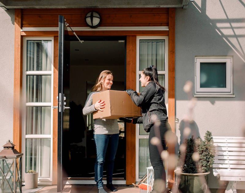 girl handing high quality moving box to homeowner